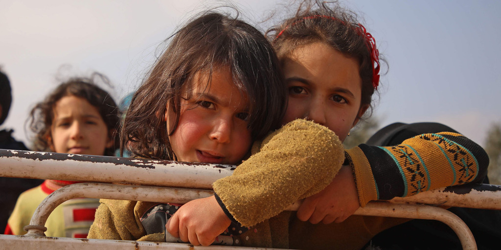 Two Syrian girls arrive at a newly established camp in Maaret Misrin in Idlib province